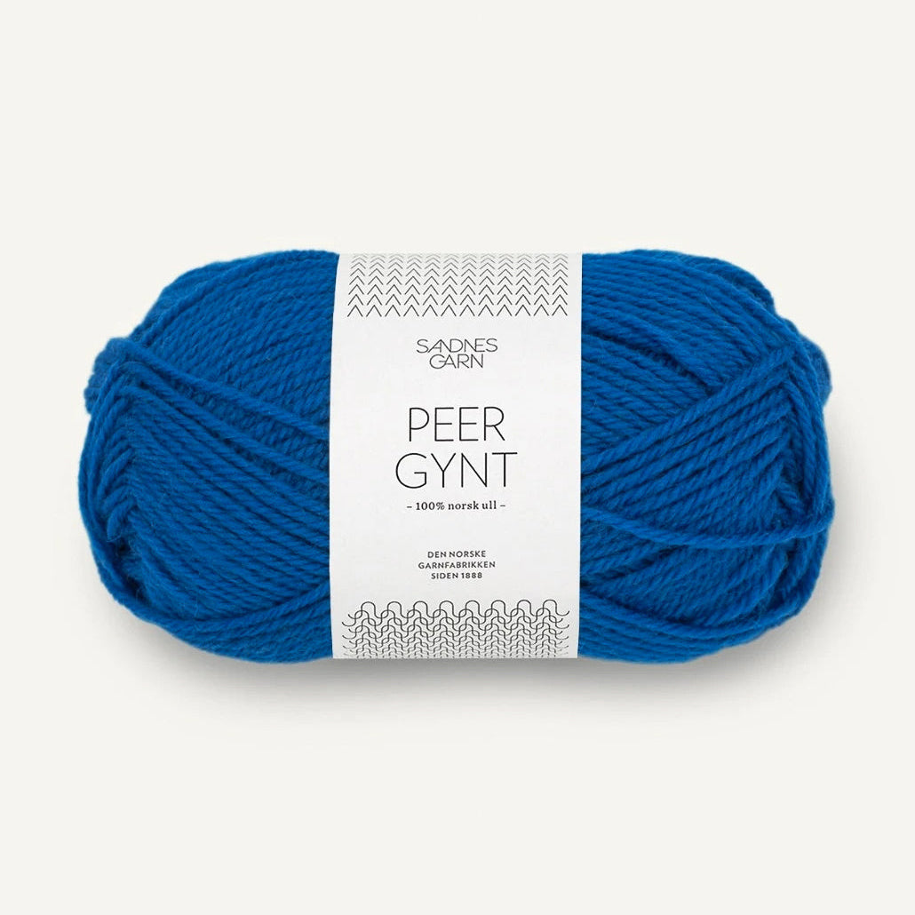 Blue skein of Sandnes Garn yarn with a label on a white background
