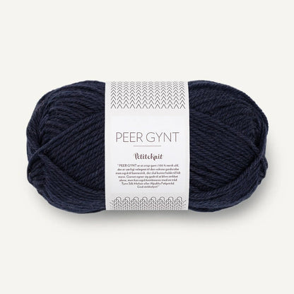 Navy skein of yarn Sandnes Garn with a label on a white background