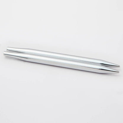 Two silver chopsticks on a white background